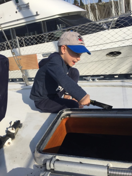 Alexander helping with boat projects